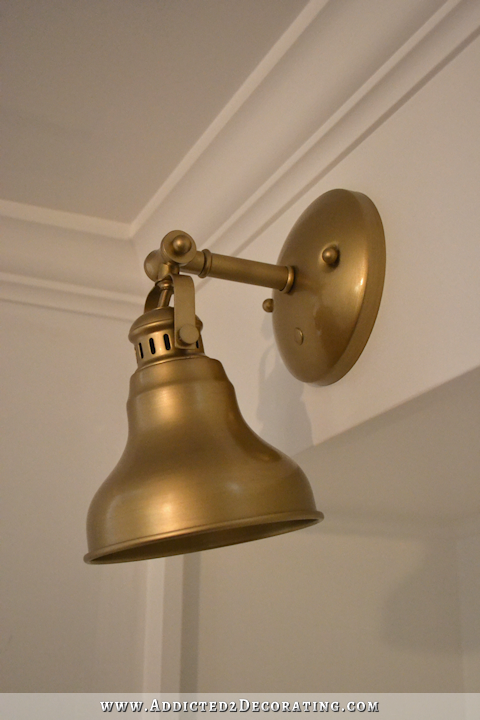 music room pocket door bookcases with brass sconces - 5