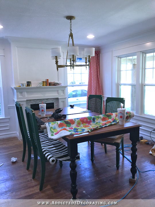 dining room fail - green chairs with striped fabric, floral watercolor fabric, and coral geometric fabric on window