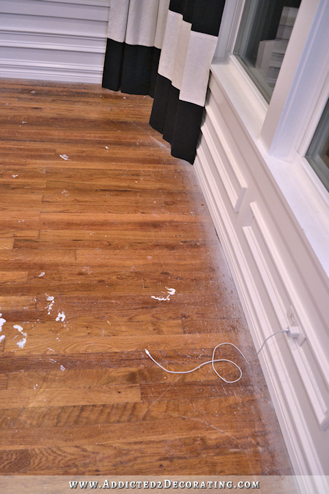 hardwood flooring with paint overspray and spills - 1