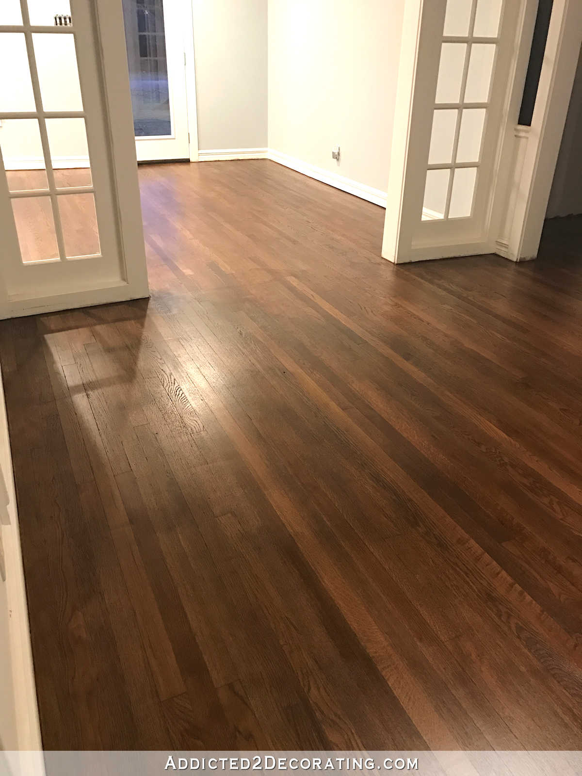 refinishing red oak hardwood floors - adding stain to first coat of polyurethane to darken the color - music room and entryway