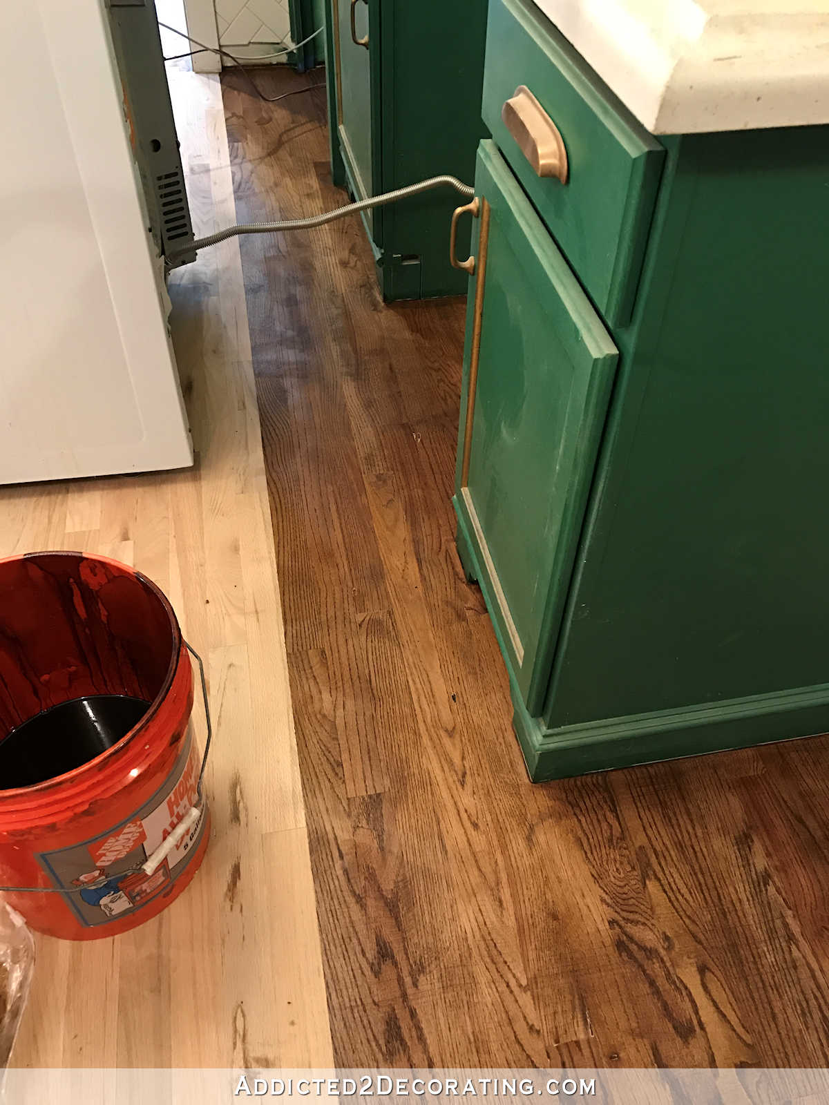 staining red oak hardwood floors - 10 - stain on kitchen floor behind stove and refrigerator