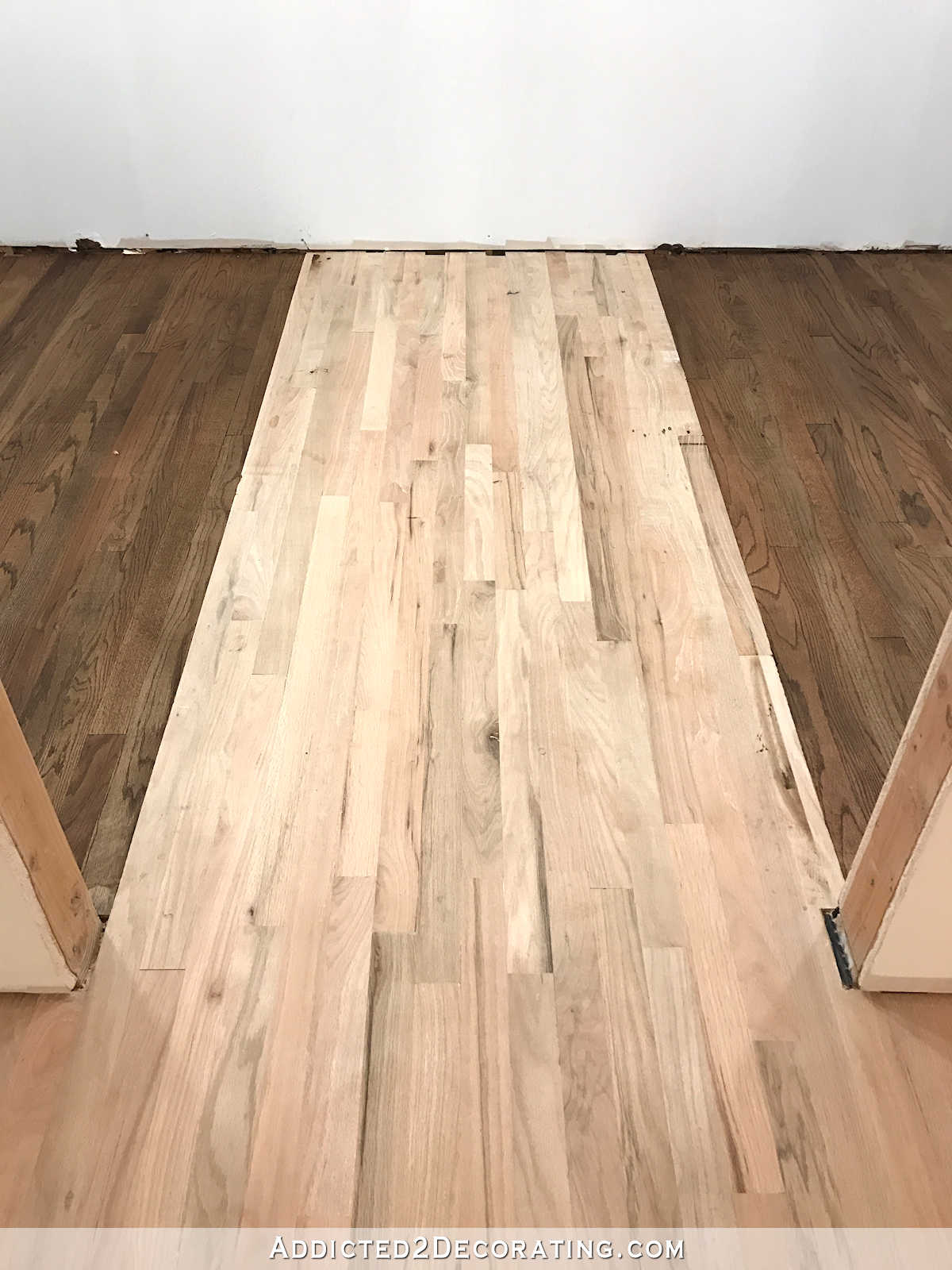 staining red oak hardwood floors - 11 - stain on left and right sides of the pantry