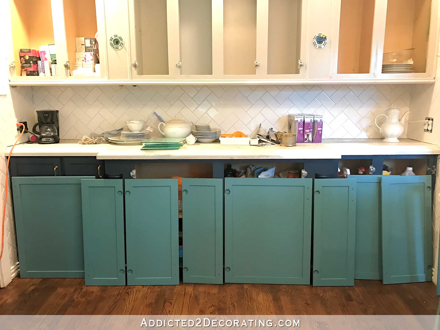 sneak peek - teal paint color for kitchen cabinets - backs of cabinet doors painted