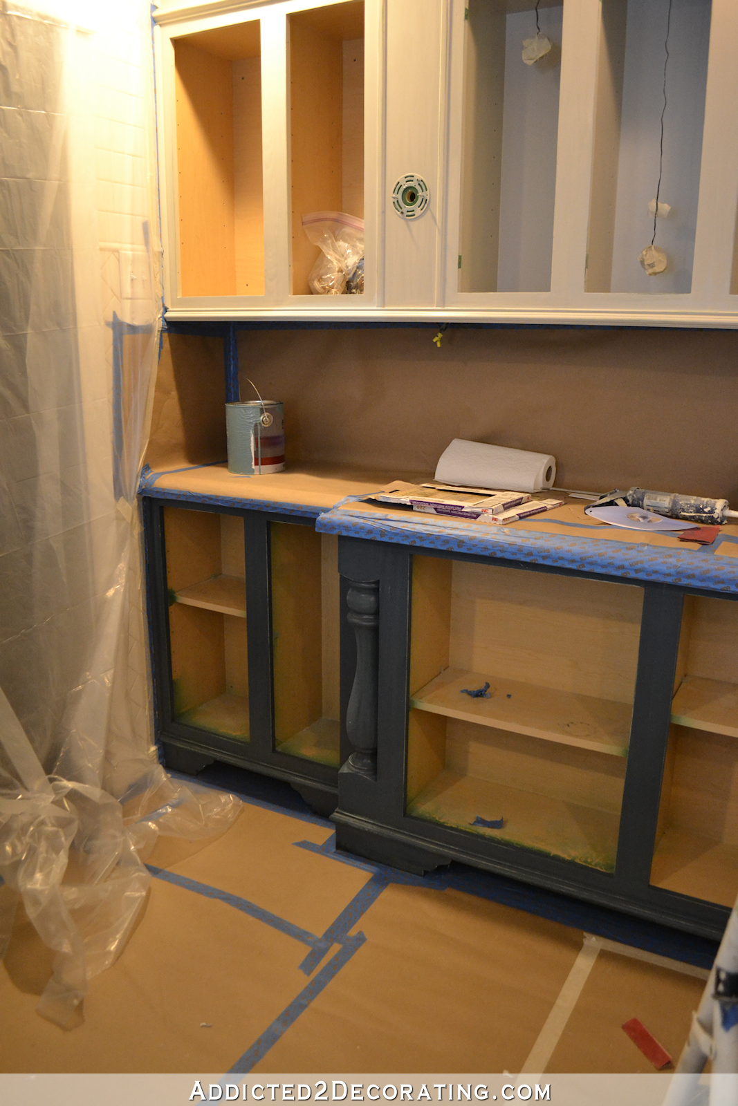 kitchen taped off and draped with plastic to prepare for spraying the cabinets - 3