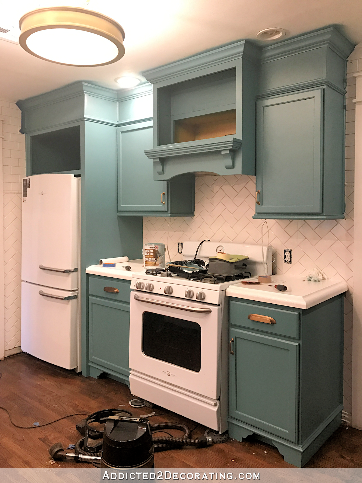 teal kitchen cabinets - range and refrigerator wall