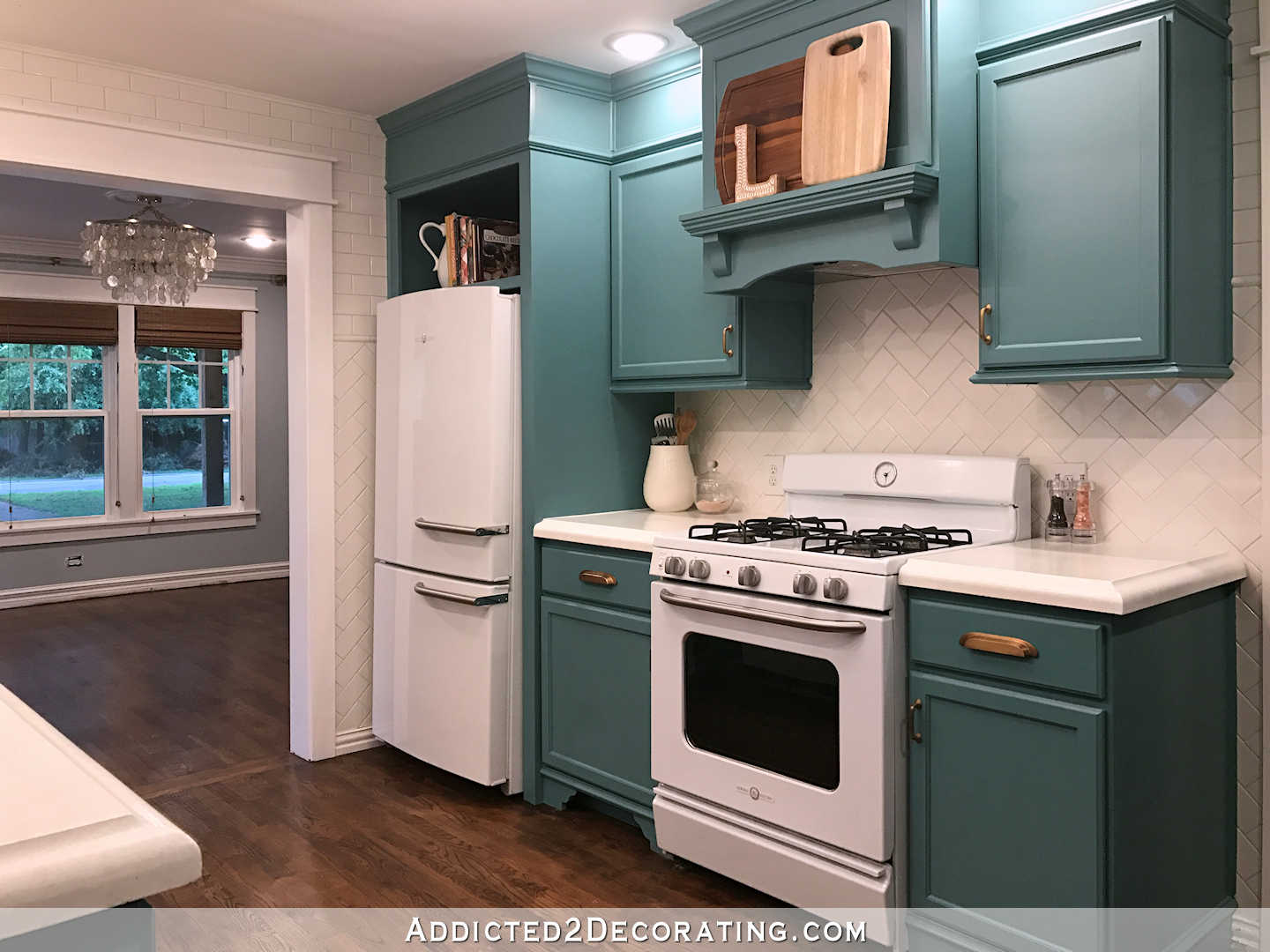 teal kitchen - refrigerator and range wall from back of kitchen