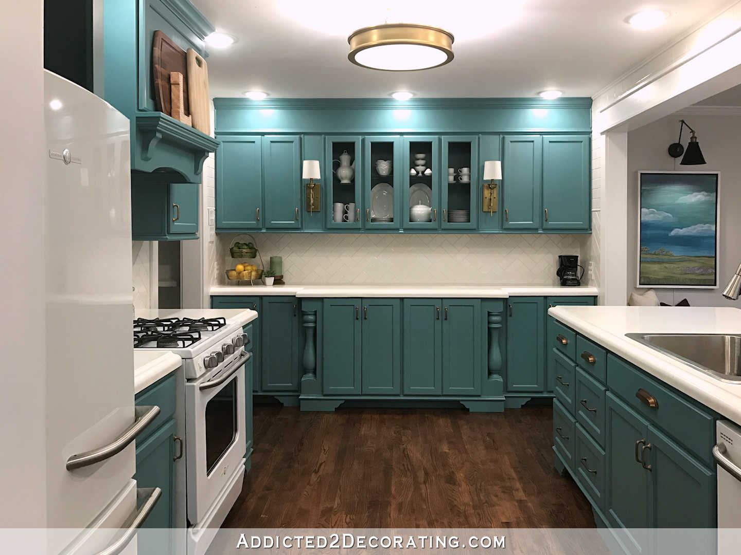 a bright kitchen with teal cabinets, mismatching tile backsplash