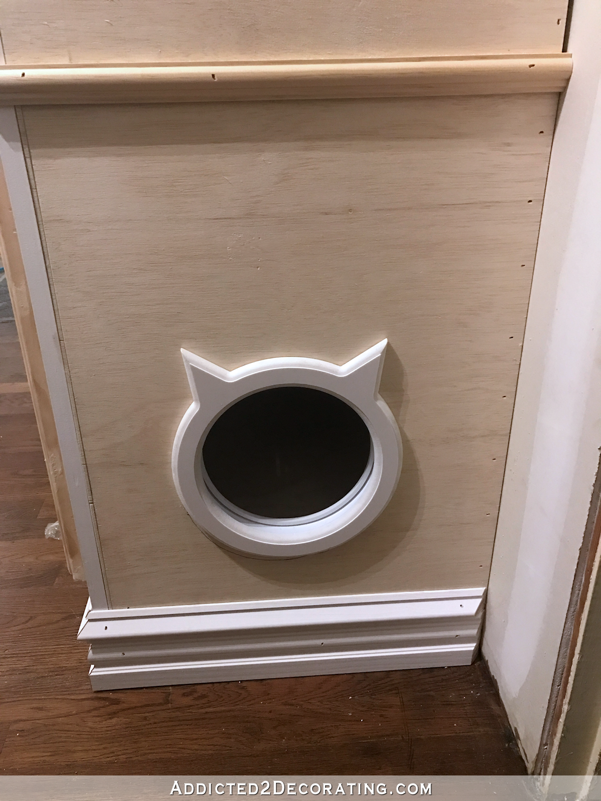 hallway cabinet progress with doors and drawer front installed - 4 - cat shaped entrance in side of bottom cabinet
