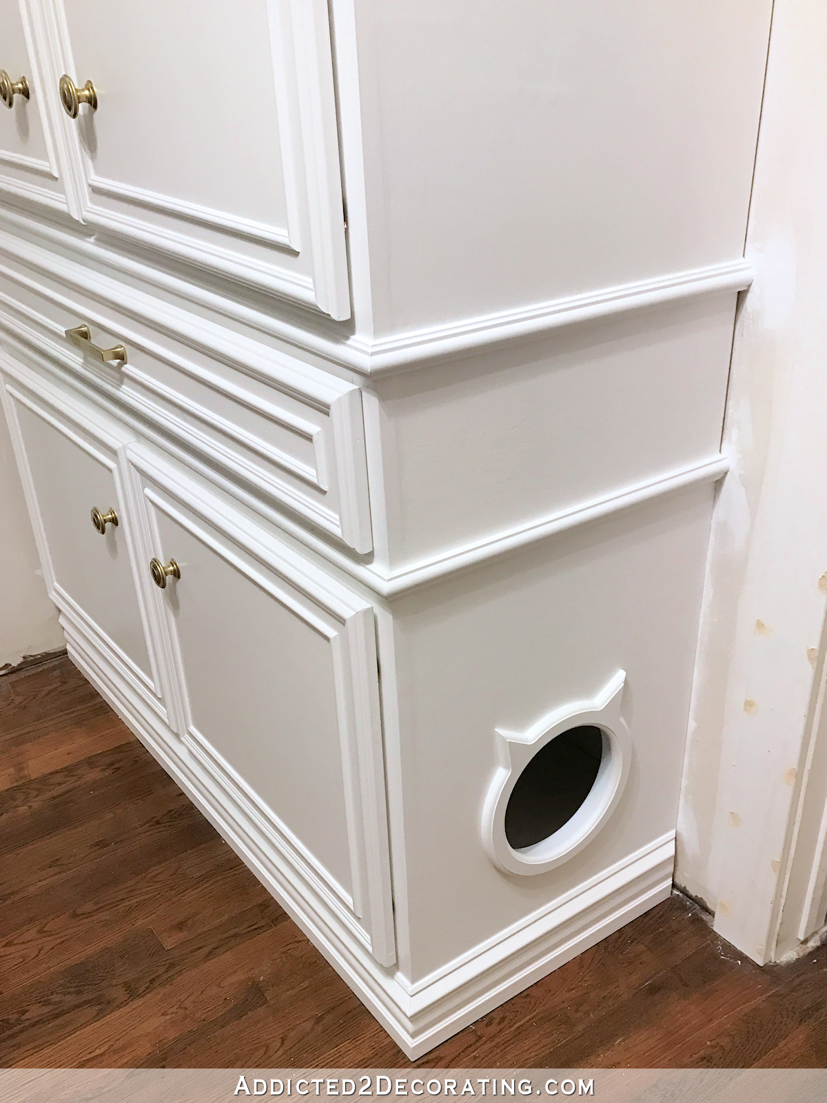 finished hallway cabinets - side of cabinet with cat door entrance to litter box