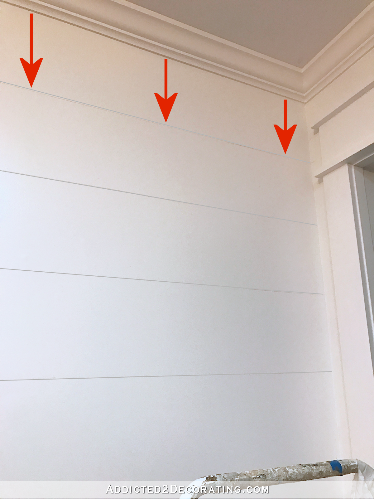 How to paint perfect stripes on a wall - 2 - use tape measure to mark lines down from crown moulding or ceiling