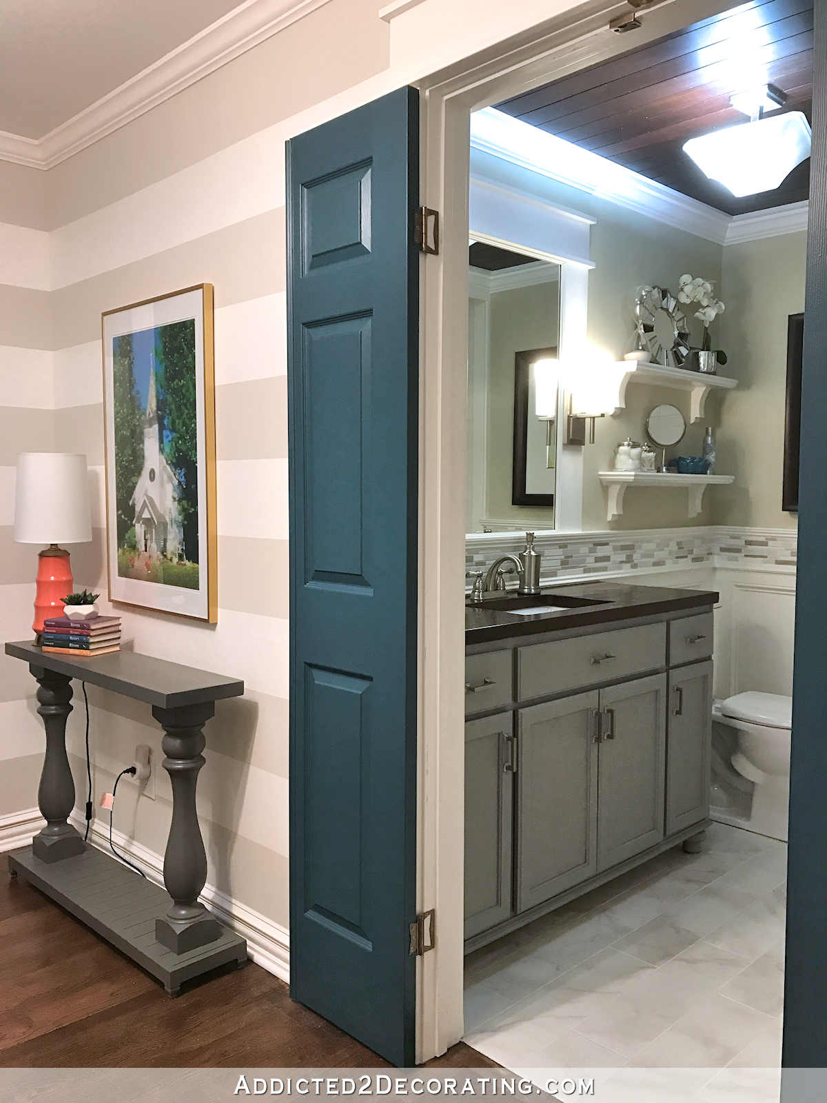 hallway with white and gray horizontal stripes, hallway bathroom with gray vanity