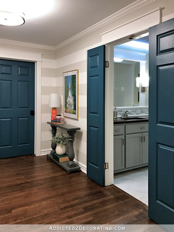 hallway after remodel - view into hallway bathroom with teal doors and gray vanity