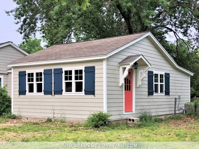 navy blue DIY board and batten shutters with black hinges pulls and shutters dogs