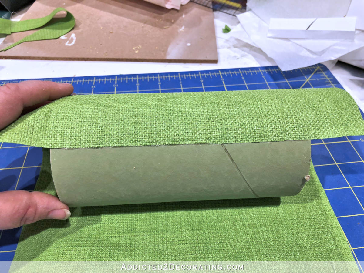 Wrapping the DIY wall sconce shades in heavy fabric - step 1