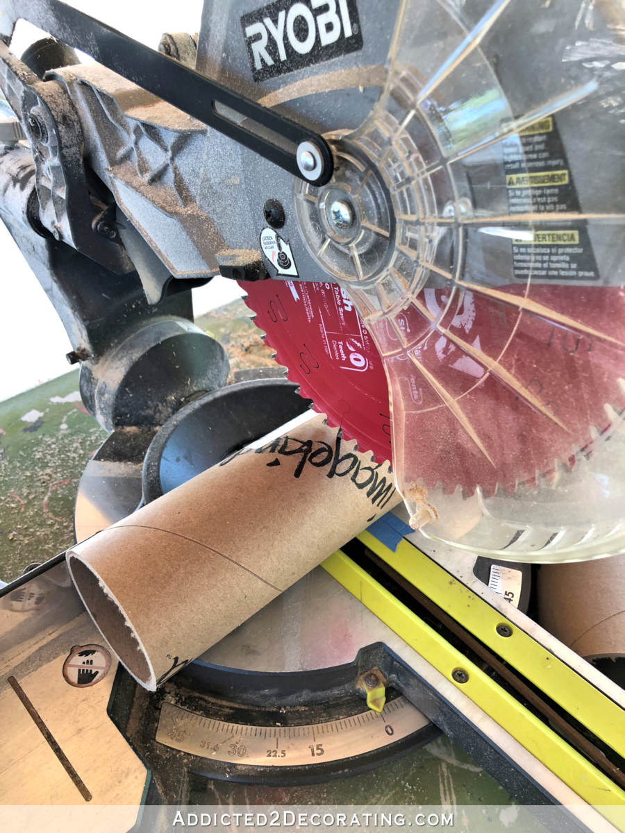 Cutting the cardboard mailing tubes to make DIY wall sconce shades 