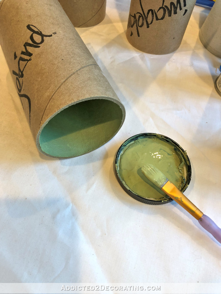 Painting the inside of the cardboard tubes to seal the surface