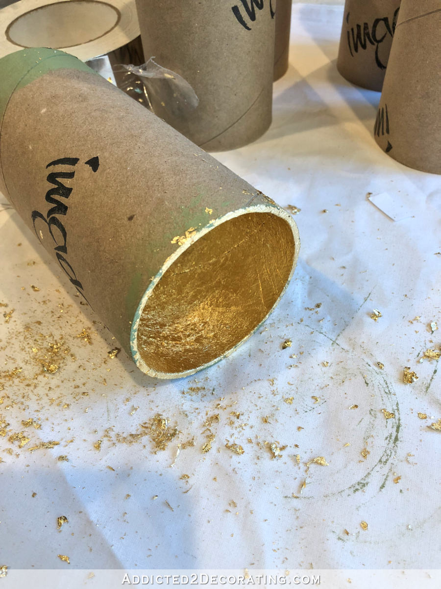 Adding gold leaf to the inside of the cardboard tubes