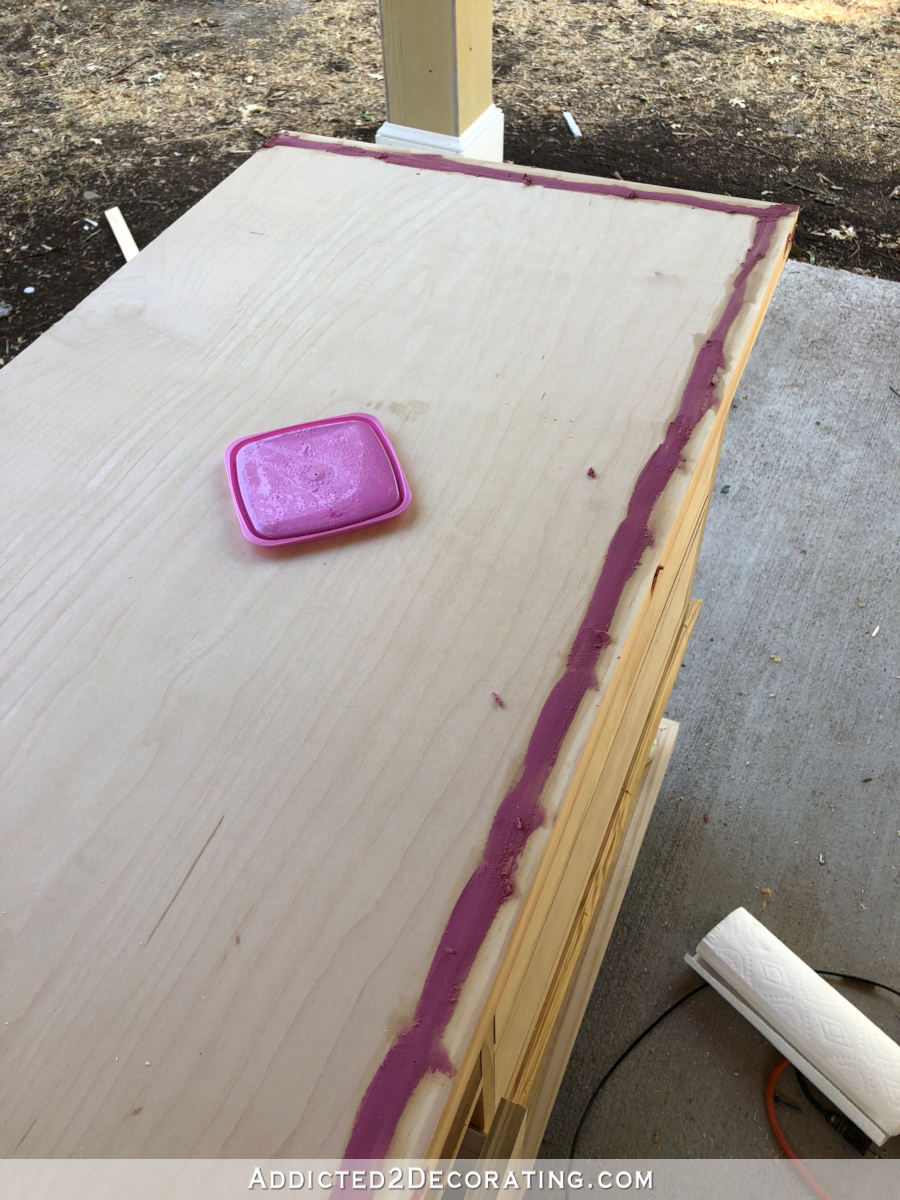 Filling cracks in the top of the console table.