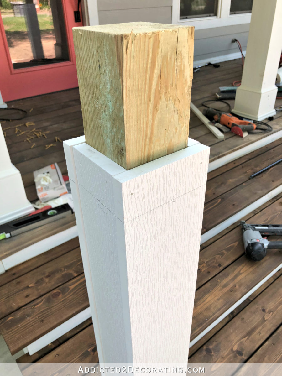 Marking the post for the height of the finished front porch handrails.