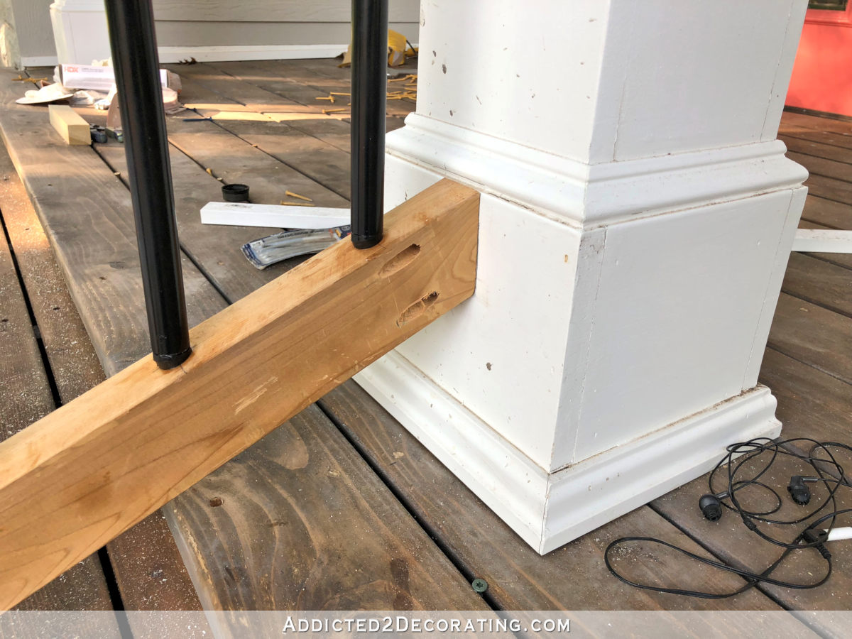 Side view of pocket holes used to attach bottom of porch step railing to the porch column.