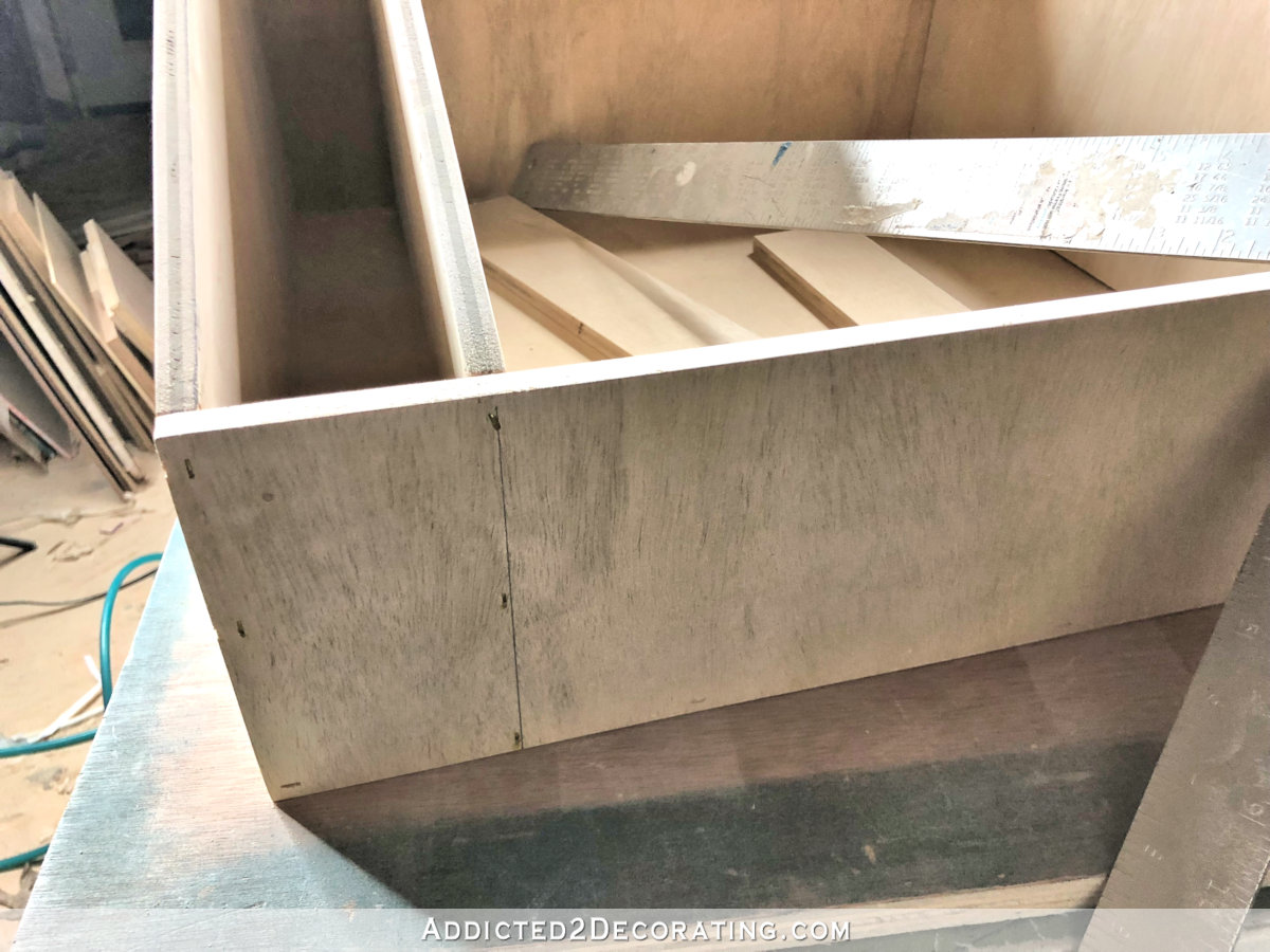 DIY pull-out slotted cookie sheet storage drawer - step 8 - attach drawer dividers with narrow crown staple gun
