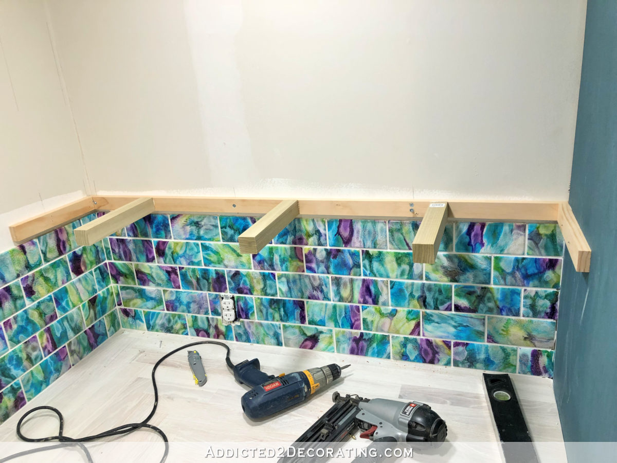 DIY floating corner shelf - attach shelf frame to wall by screwing it into studs