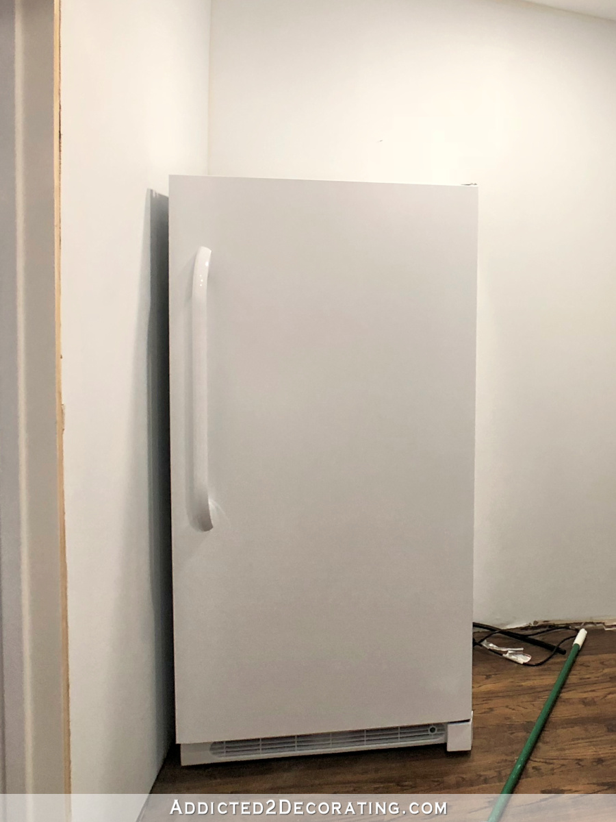 Plain white upright freezer with a textured surface - before I painted it