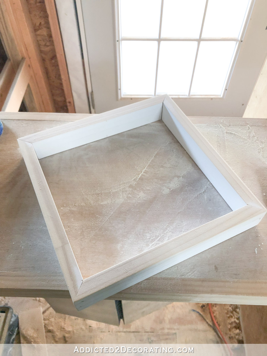 Easy DIY shadow box frame - step 1 - cut four pieces of 1 x 2 lumber and nail together in a square