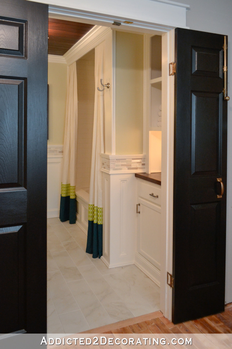 Small bathroom remodel - linen closet replaced with lower cabinet, wood countertop, and upper open shelves.