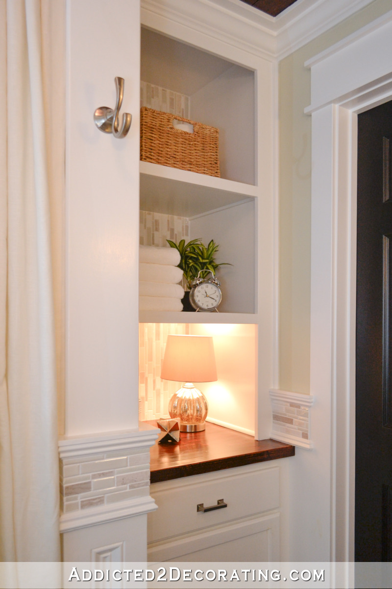 Cabinet and open shelves built to replace an original linen closet in a small bathroom