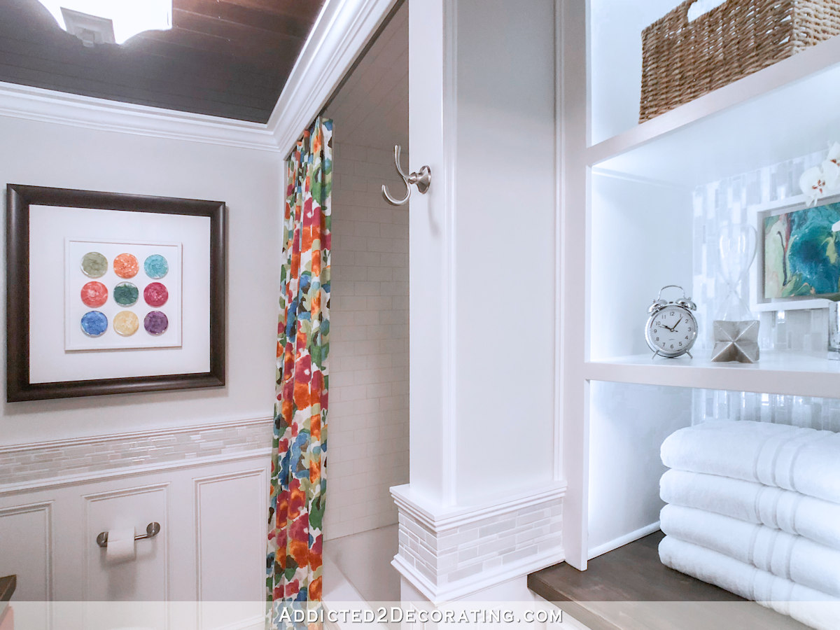 Small bathroom makeover with colorful floral shower curtain.