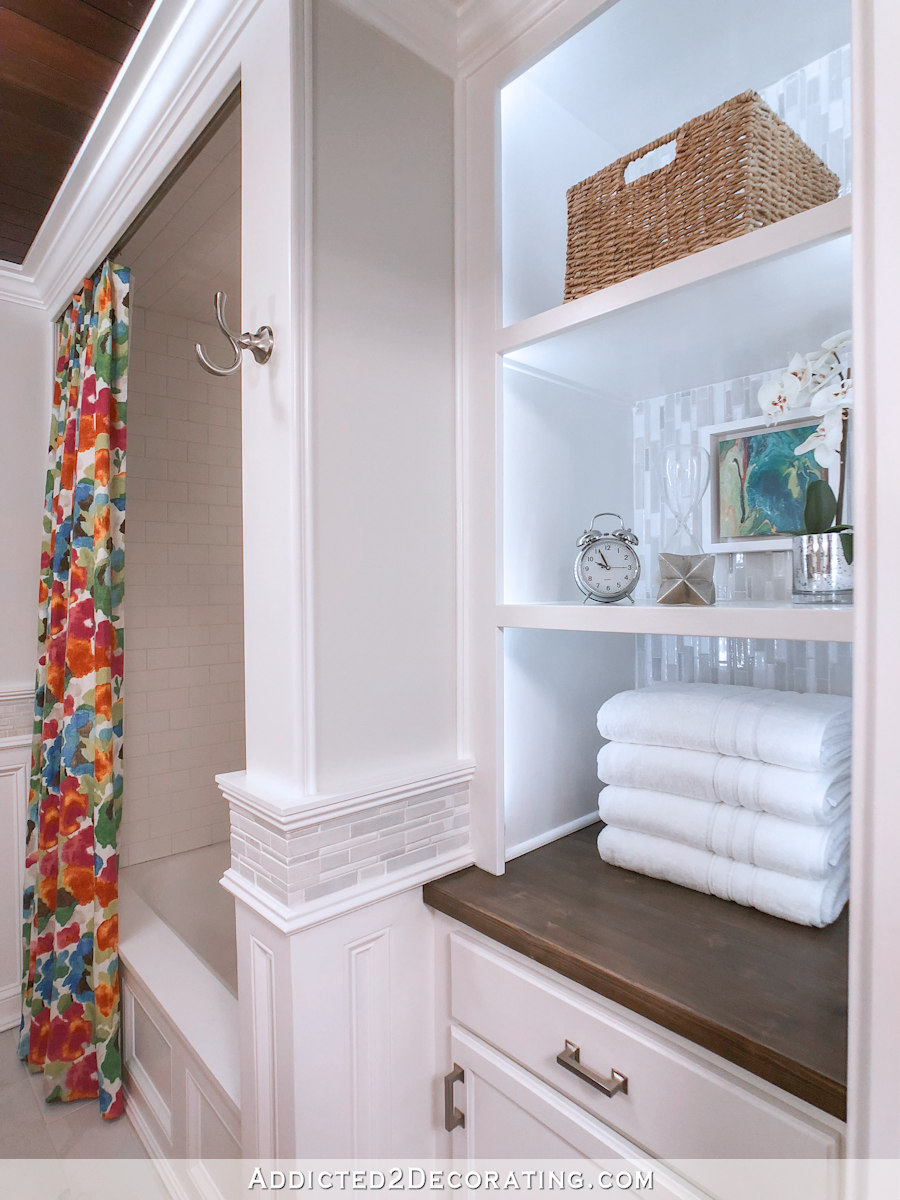 before and after of painted tile in a bathroom with floral shower curtain 