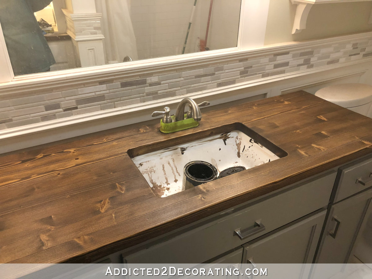 Refinishing a pine wood countertop - first coat of dark walnut wiping stain.