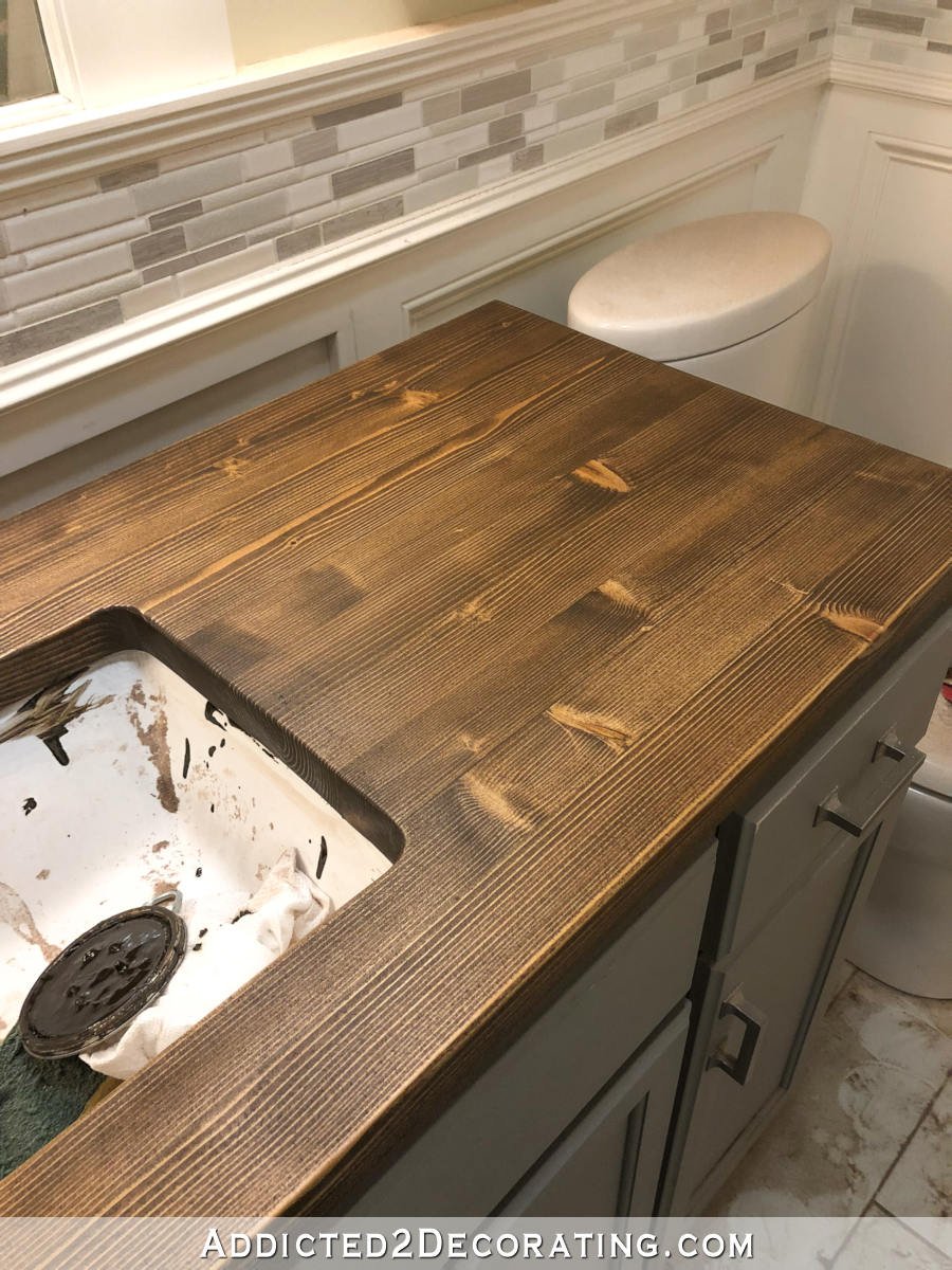 Refinishing a pine wood countertop - first coat of wiping stain in dark walnut.