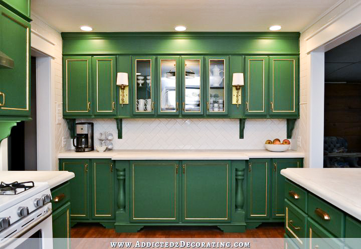 kitchen with kelly green cabinets and white tiled walls