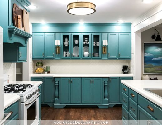 kitchen remodel with teal cabinets and white subway tile on walls