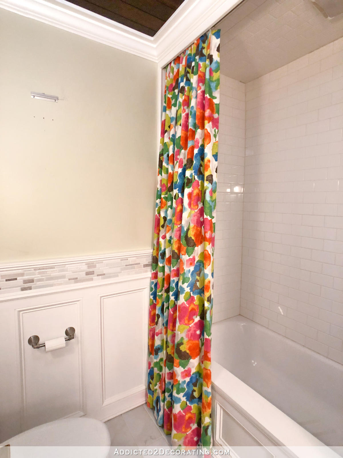 DIY shower curtain in a bright watercolor floral fabric.