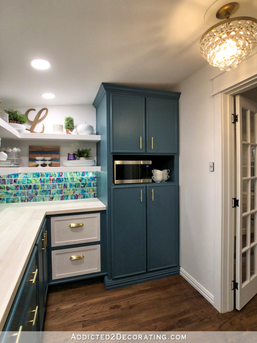 tall pantry cabinet with pull out shelves and open shelf for microwave