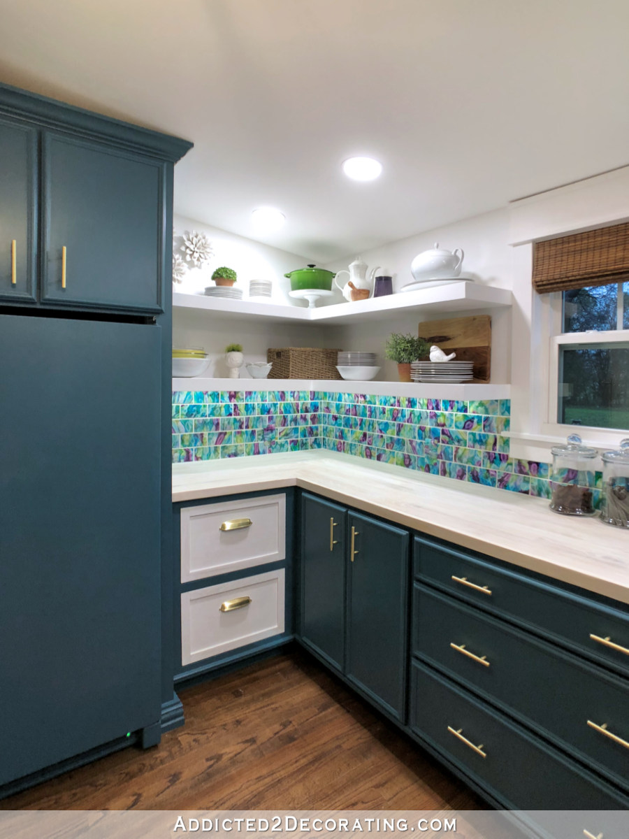 butlers pantry design with teal cabinets, upper open shelves, and a painted upright freezer