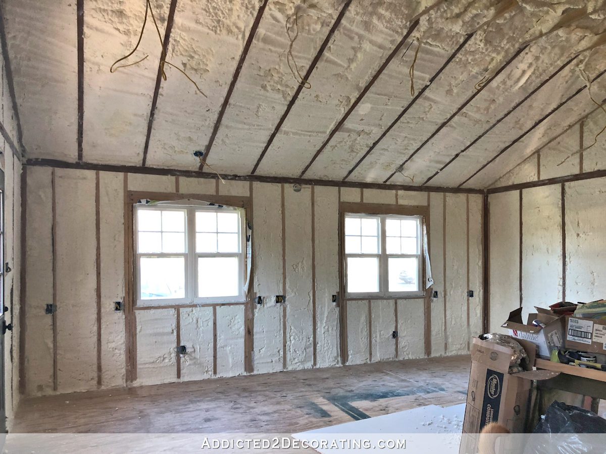 front wall of studio with spray foam insulation in walls and vaulted ceiling