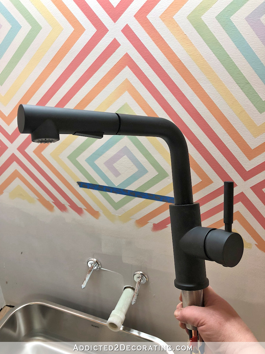 short kitchen faucet with pull out sprayer that I'm using in the half bathroom