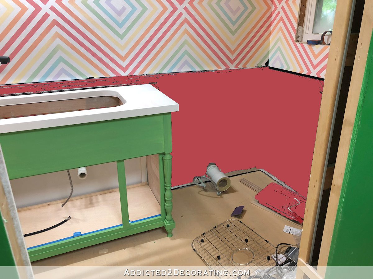 green vanity with pink wainscoting