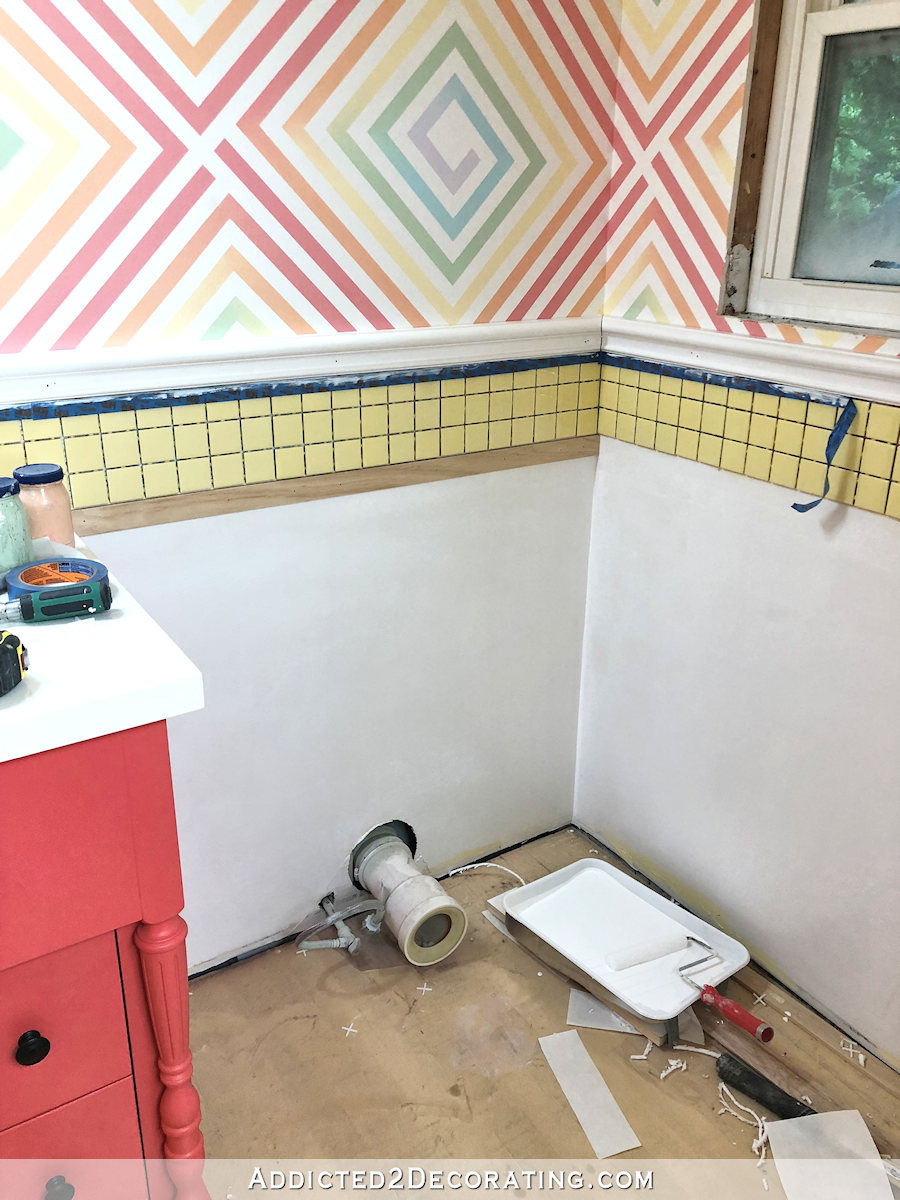 yellow bathroom tile with white wainscoting