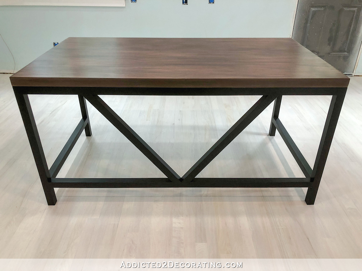 Large DIY writing desk with black base and stained top made from a solid core door