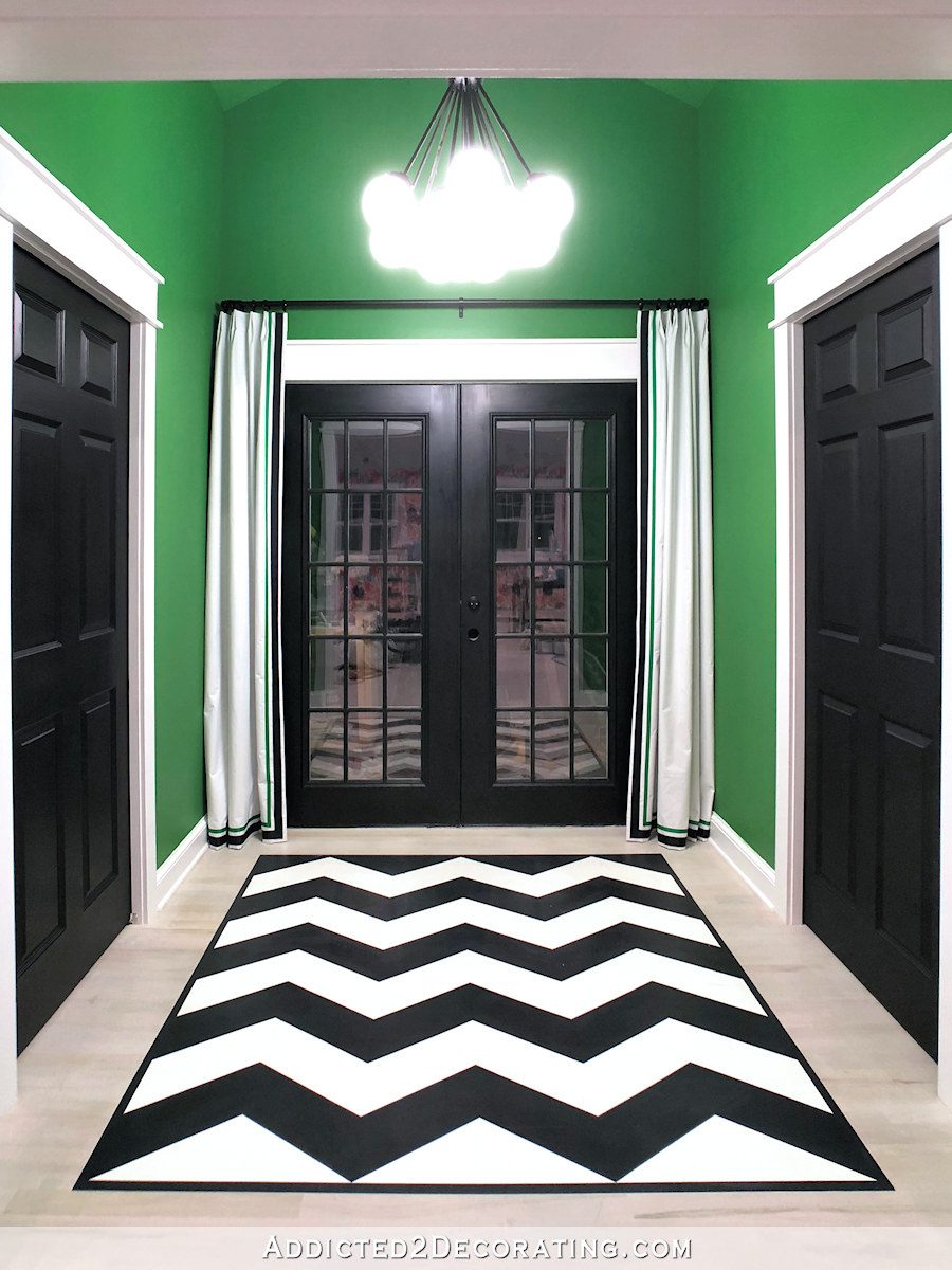 studio back entry with painted chevron floor and green walls