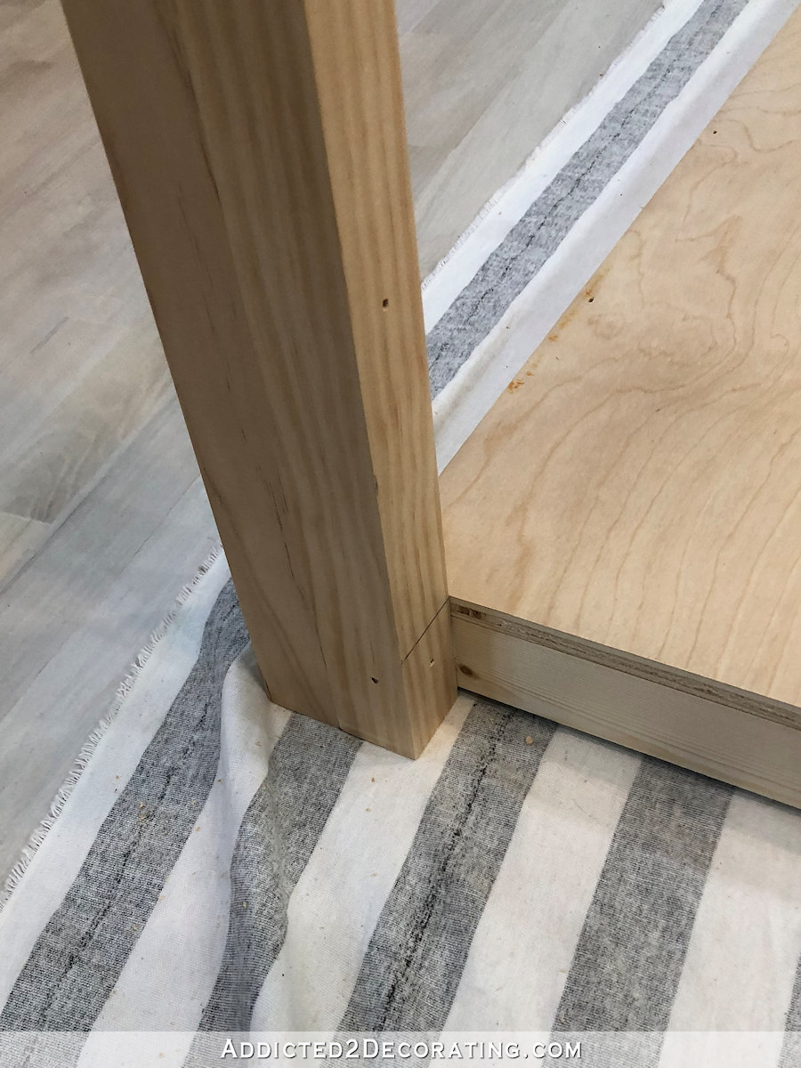 how to build a big craft table - 11 - attach legs to bottom shelf with nails