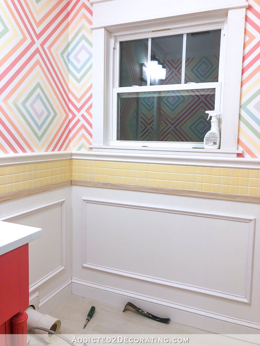 half bathroom walls with picture frame molding and baseboards installed