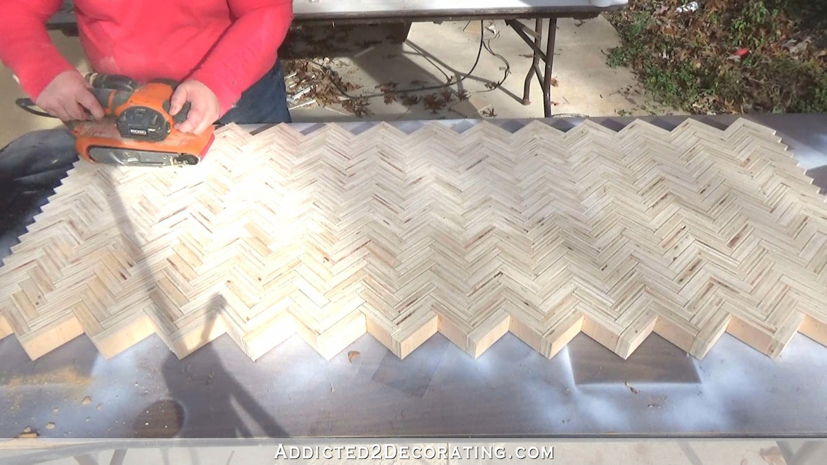 How to build an edge grain plywood herringbone coffee table - step 7 - sand table top wtih belt sander