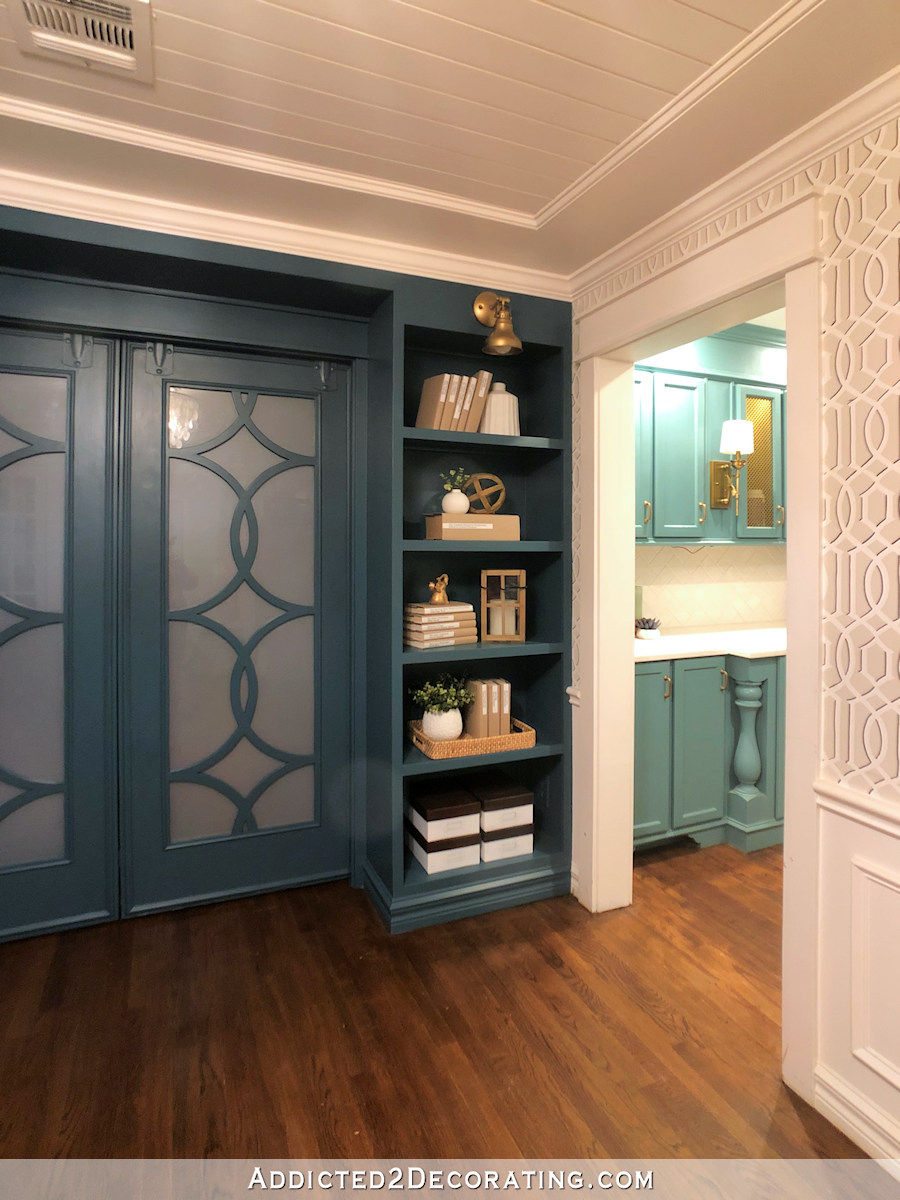 music room with teal bookcases - 1