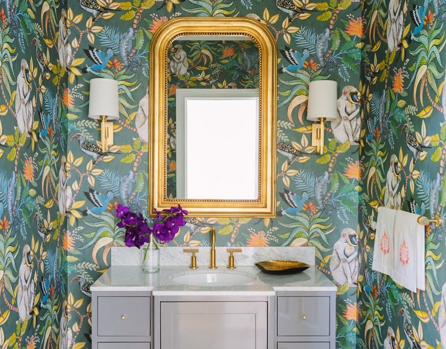 Bathroom with tropical wallpaper featuring leaves, birds, and monkeys, by Sarah Vaile Design (@sarahvailedesign) on Instagram